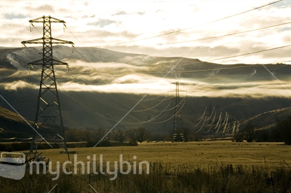 Sunrise over Central Otago as it catches the powerlines