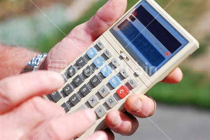 Farmer tallies up using a calculator designed for rugged fingers