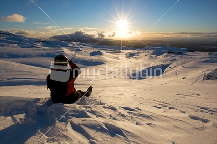 A skier watching the sunset from Whakapapa ski field, Mt Ruapehu