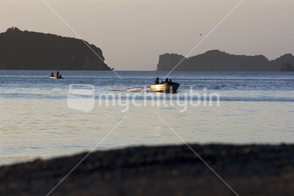 A fishing boat and islands at sunset, Coromandel, New Zealand
