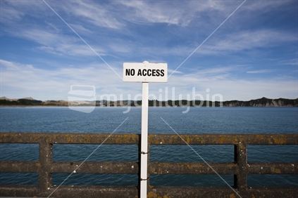 A sign on a pole on Tolaga bay wharf, New Zealand