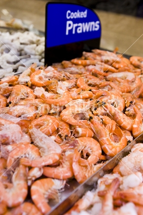 Cooked prawns on display in a refrigerated cabinet.