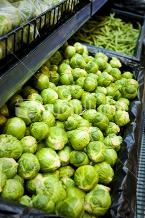 Brussell sprouts on display at a supermarket.