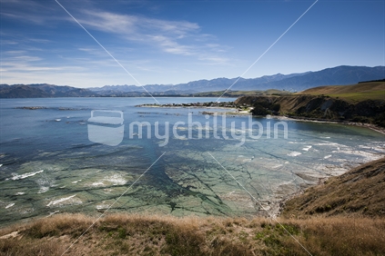 A view of the New Zealand Kaikoura coastline and Kaikoura ranges from a walkway lookout point.