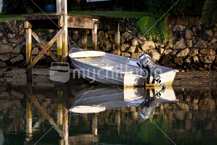 A dinghy tied to a jetty in calm water at Whitianga, Coromandel, New Zealand.