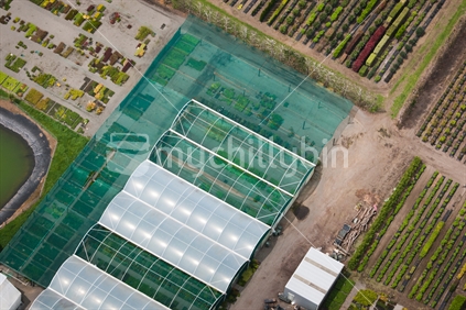 Aerial photo of a hothouses and rows of plants at a nursery.