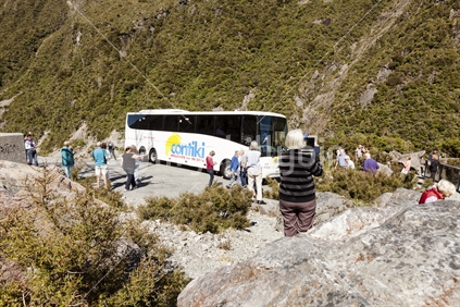 Tourist taking an ipad photograph near Arthurs pass.