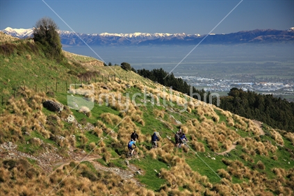 People exercising above Christchurch with southern alps in background