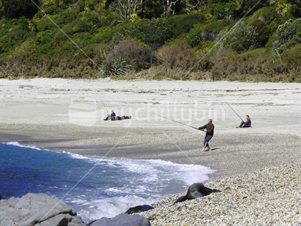 People fishing along the beach