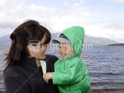 Mother and son at the lake having fun 