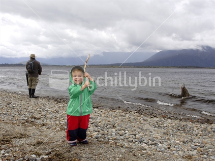 Boy with a stick pretending it's a fishing rod
