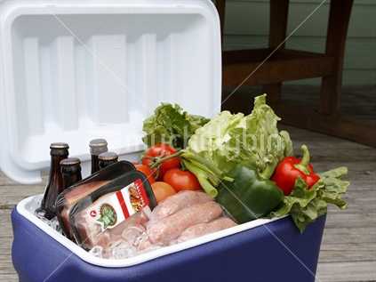Chilly bin with drinks, meat and salad vegetables for BBQ