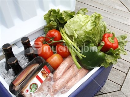 Chilly bin with drinks, meat and vegetables for BBQ; iconic NZ chilly bin.