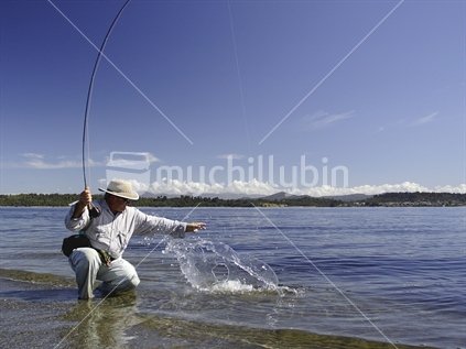 Fly fishing on the shores of Lake Brunner, West Coast, South Island