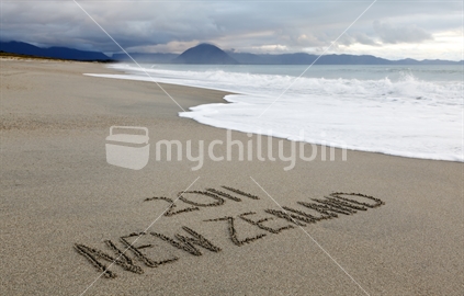New Zealand 2011, written in the sand, coastal New Zealand.  Advertise and support New Zealand events in 2011.