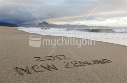 New Zealand 2012 written in the sand, coastal New Zealand.  Advertise and support New Zealand events in 2012.