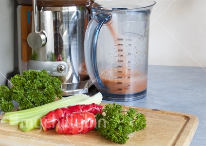 Juicing raw fresh vegetables for good health.