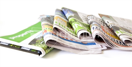 Folded newspapers and property press.