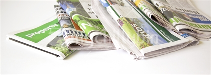 Folded newspapers and property press.