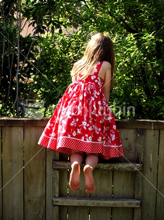 Girl peaking over fence
