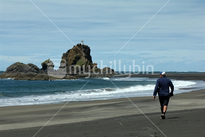 Man walking on west coast beach