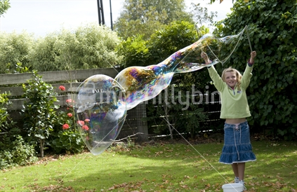 Young girl making huge Bubbles