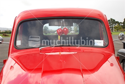 Fluffy dice in a red car