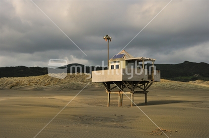 The Life Gaurd Station at Bethells Beach surrounded by a very Stormy Sky.

