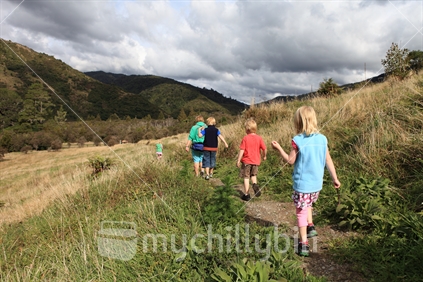 Young family walking at Otaki Forks, Tararua Forest Park, New Zealand