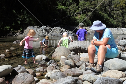 Family on Hutt River at Kaitoke Regional Park, New Zealand