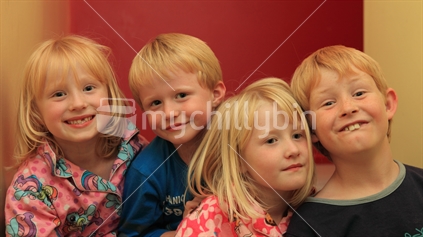 Four young Kiwi kids smiling 