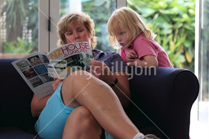 Mother & daughter sharing a magazine.
