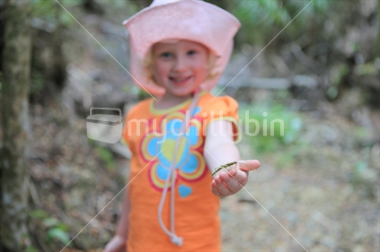 Young girl holding stick insect