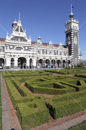 Dunedin Railway Station with decorative hedge in foreground (Raised ISO)