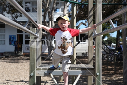 Young boy in climbing frame