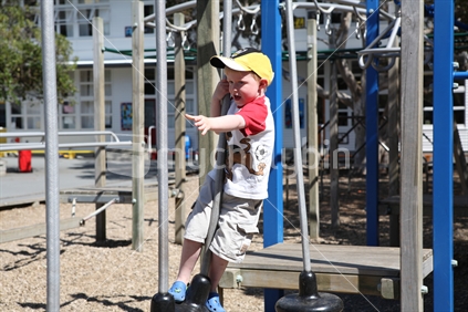 Young boy on climbing frame