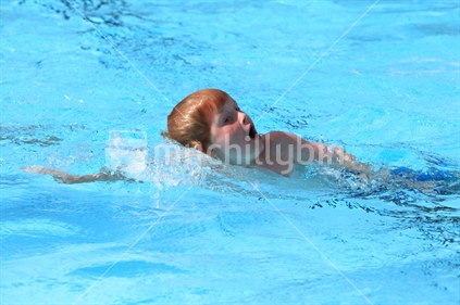 Young boy in a swimming race