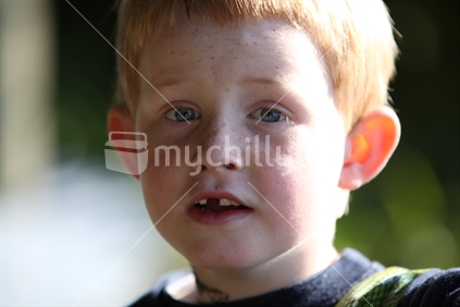 Young boy with missing front tooth