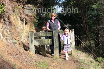 Woman and children on bush walk, New Zealand