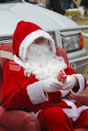 Santa Claus giving ice creams to children 