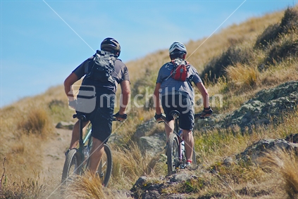Two mountain bikers having a weekend ride on the Port Hills Canterbury, New Zealand