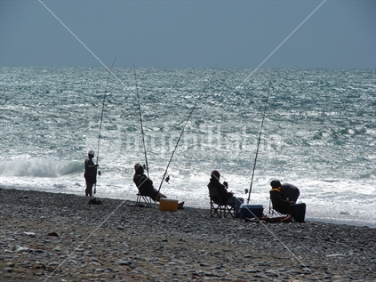 Fisherman at the Nape Nape fishing competition relaxing in their deck chairs waiting for a bite, New Zealand