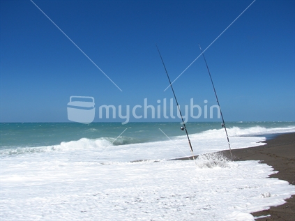 Two surfcasting rods anchored to the beach 