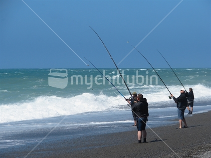 Four fisherman surfcasting
