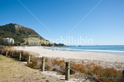 Magnificent Mount Maunganui on horizon, with beach and walkway.