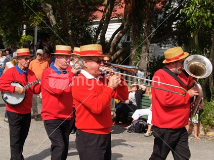 Jazz musicans march through the Tauranga Historic Village during an annual National Jazz festival.
