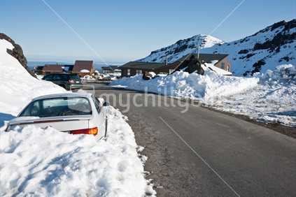 Stuck in the snow. Car deep in snow beside road at Mount Ruapehu.