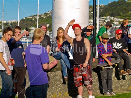 Attitude; a group of young people loiter around in Wellington's waterfront - enjoying the warmth of spring.