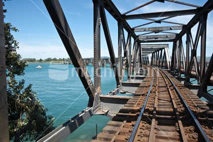Looking along railway bridge structure, Tauranga harbour.