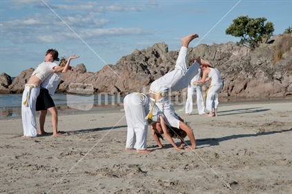 Capoeira Tauranga, members practicing on Mount Maunganui beach, New Zealand.
Capoeira is considered an art, a sport and a philosophy by it's followers. It was founded in Brazil in 1984.